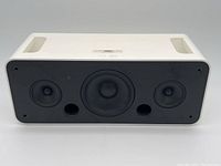 Front view of the Apple iPod Hi-Fi A1121 speaker system showcasing three speaker drivers in black panel with white casing and built-in handles on top.