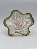 Photo of art glass bowl showing wavy edges and gold stripes from above
