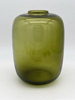 Front view of the tall green glass vessel showing its smooth cylindrical shape and glossy surface.