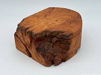 Live edge burl wood box viewed from front angle showing wood grain and live edge natural shape.