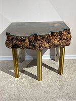 Live edge burl wood side table with custom waterjet cut glass top and brass/stainless steel legs, front view.