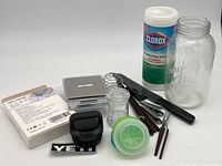 Overview of miscellaneous kitchen items including scale, Yeti cap, hardwood chip sticks, mason jar, fruit fly lids and Clorox wipes.