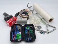 Photo showing the entire lot with tools, tapes, paper towel roll, vacuum attachment, and optical tools
