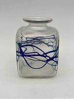 Front angled view of vase showing the abstract blue line design and iridescent sides.