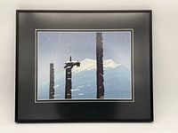 Full view of framed print showing black frame, double white mat border, snow scene with totem poles and mountain