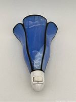 Front view of the blue stained glass night light plugged in with visible white plastic base and toggle switch