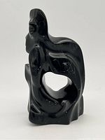 Front angled view showing overall shape, carved face, and open cut-out.