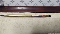 Full view of vintage gold filled mechanical pencil showing entire length and tip.