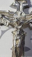Close-up of Christ figure and decorative cross ends