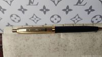 Side view of the vintage Remington ballpoint pen showing black barrel, gold clip, and push-click button.