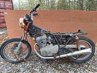 Side profile of the 1973 Yamaha TX500B frame and twin-cylinder engine showing vintage exhaust pipe and rear suspension shocks