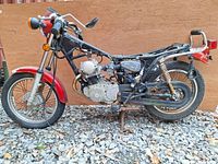 Side view full frame of the 1981 Yamaha SR185H without seat and some missing parts, showing engine and front wheel