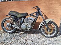 Full side profile of 1981 Yamaha XJ550 SECA salvage motorcycle showing frame, engine, front forks, handlebars, and front wheel with disc brake.