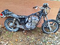 Side view of the Yamaha XJ550H frame with engine and rear suspension showing tires, engine block, and partial wiring.