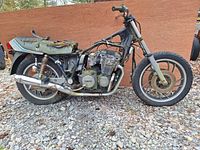 Side view of the Yamaha XJ650J Seca motorcycle salvage with visible frame, engine, worn seat, rear wheel, suspension and exhaust