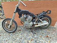 Side view of the stripped 1983 Yamaha XV500 Virago motorcycle frame with engine, rear wheel, and high raised handlebars