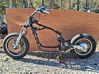 Side profile of partially assembled 1985 Yamaha Venture Royale motorcycle frame with front and rear wheels.