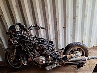 Side view showing the main frame, engine, wiring harness, rear wheel with tire, exhaust system, and partial seat base of the Yamaha 1300 Venture Royale motorcycle.