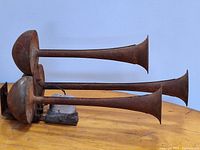 Side view of triple trumpet horns showing length and mounting bracket