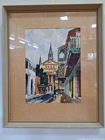 Full view of framed watercolor painting showing street scene with church and balconies in Mid Century Modern style.