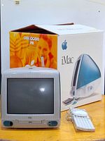 Front view showing iMac, keyboard, mouse and box