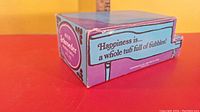 Close-up side view of Avon Schroeder bubble bath box with text 'Happiness is a whole tub full of bubbles!'