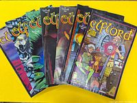 Set of 8 Elflord comics laid out fanned on yellow background showing varied colorful covers with fantasy art.
