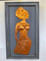 Full view of hammered copper woman art piece mounted in wooden frame