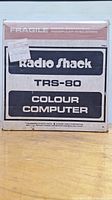 Front of original box labeled Radio Shack TRS-80 Colour Computer with fragile notice