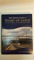 Front cover of softcover book showing title, author's name, and Kirkland Lake street scene.