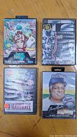 Front view of 4 Sega Genesis game cartridges with cover art: Taz-Mania, T2 The Arcade Game, Tommy Lasorda Baseball, Sports Talk Baseball