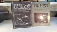 Closed book and slipcase showing the cover titled 'The Ultimate Fishing Book' with fishing illustration on dust jacket.