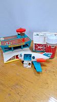 1972 Fisher Price Play Family Airport with attached control tower and airplane sitting on table