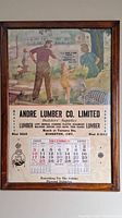 Full view of framed calendar advertising showing family scene and company details.