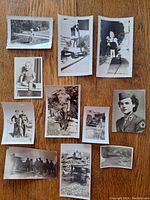 Collection of 11 black and white vintage family photographs laid out on a wooden surface, showing children, adults in uniform, and outdoor scenes.