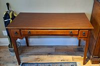 Front and top view of the hardwood desk showing the drawer and surface condition