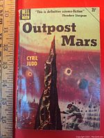 Front cover of 'Outpost Mars' paperback showing author, title, Dell publishing and price