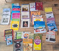 Wide view of the collection showing all piano and accordion books laid out on a wooden floor.