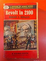 Front cover of 'Revolt in 2100' paperback book shows original 35 cent price, red background, sci-fi themed illustration, and publisher Signet info.