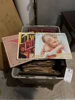Bin packed with a large collection of vinyl records and some 78 RPMs, with three albums displayed on top: The Bee Gees, Van Halen 1984, and Dan Fogelberg Phoenix.