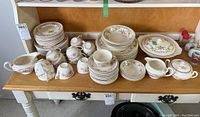Full overview of all Sovereign Earthenware dishes arranged on a table showing plates, teacups, saucers, serving pieces.