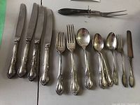 Assortment of dinner knives, forks, spoons, small fork, small knife and two-tine carving fork