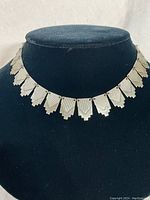 Front view of the Art Deco sterling silver choker necklace on a black velvet bust display, showing the entire linked pattern.
