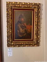 Full-frontal view of framed painting hung on wall