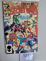 Front cover of Marvel Superheroes Secret Wars #5 comic book showing vibrant artwork of multiple Marvel superheroes including Spider-Man, Wolverine, Iron Man, Captain America, and others in action poses. The cover price is 75 cents and it is a 12-issue limited series.