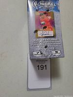 Sealed unopened box of 2021 Skybox Metal Universe Champions 5 Pack Blaster Box with front label showing promotional details about exclusive autographs and gold promo cards.