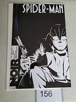 Front cover of Spider-Man Noir #1 variant comic book showing the character holding a gun in black and white.