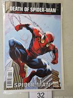 Front cover of Ultimate Spiderman #156 featuring Spider-Man swinging in cityscape with 'Death of Spider-Man' title