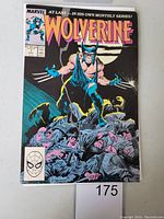 Front cover of Wolverine #1 comic book showing Wolverine standing on a pile of armed men with a moonlit sky behind.