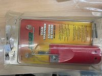 Front view of the laser chainsaw chain sharpener in original retail packaging, showing product and label details.